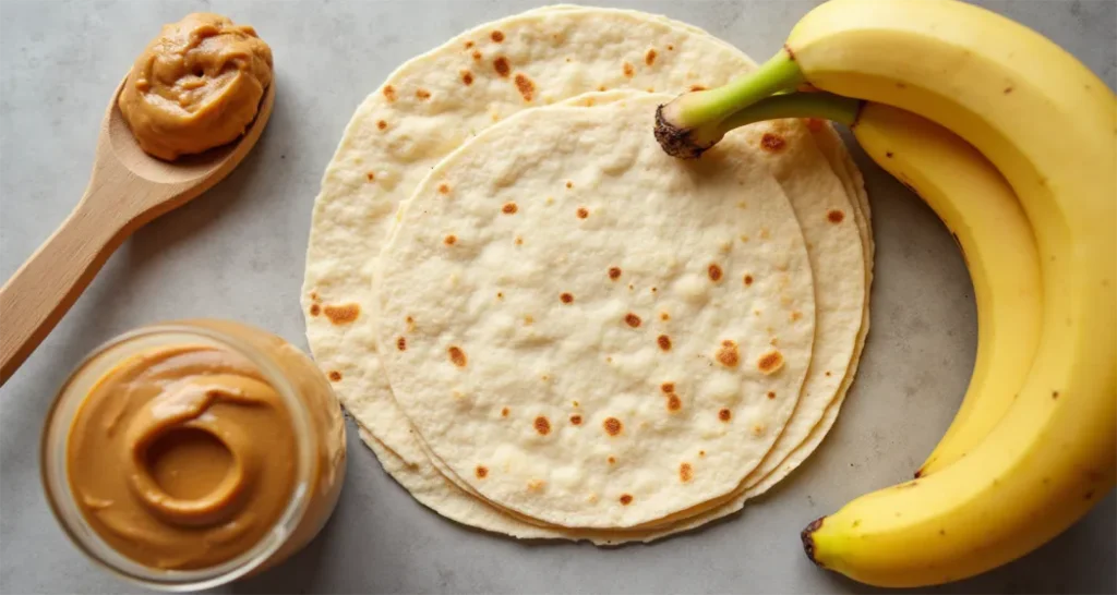 core ingredients (tortilla, peanut butter, bananas) arranged on a table.