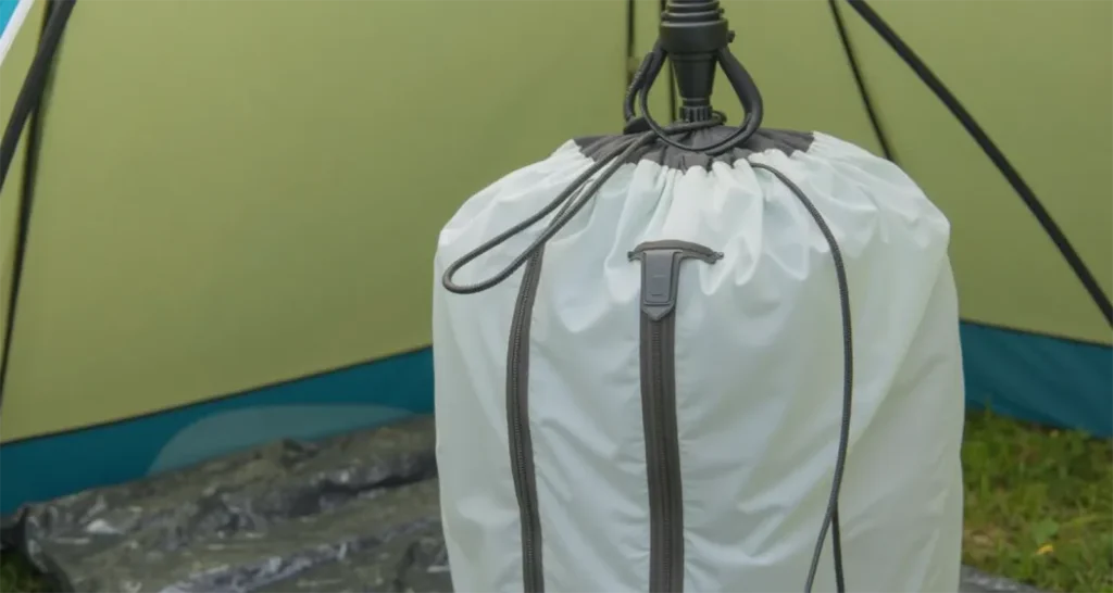 Portable camping shower bag being used inside a shower tent.