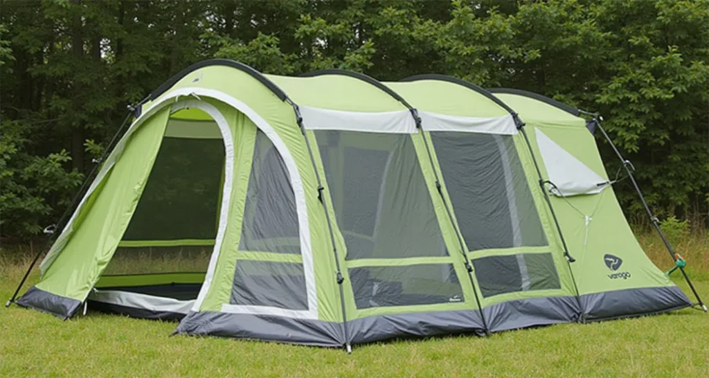 Vango Odyssey Air 500 inflatable tent set up in a lush forest campsite.